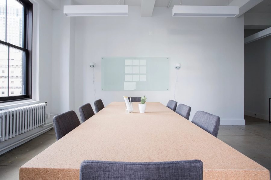 An empty meeting room beside a glass wall