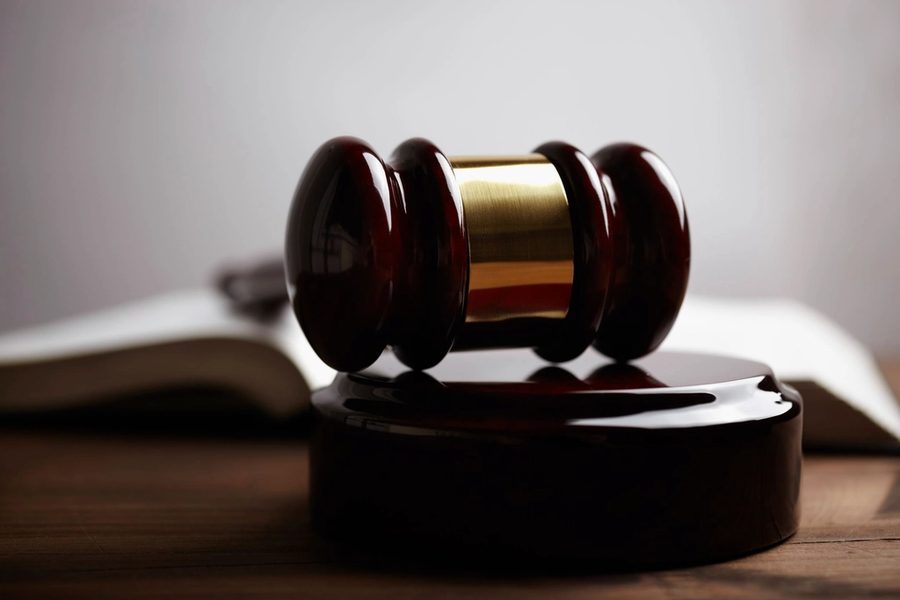 A judge's gavel resting on an open book
